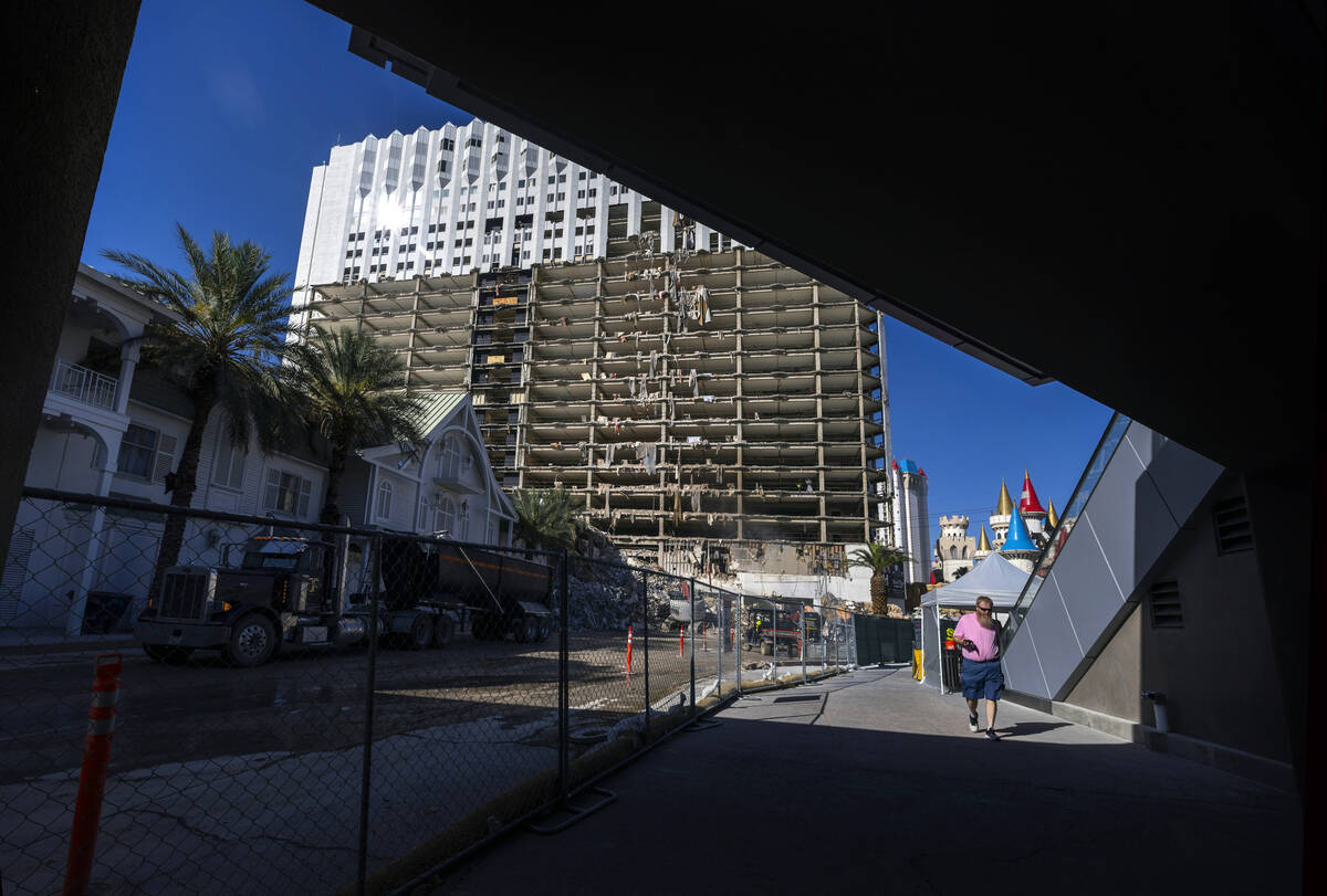 File - A pedestrian walking beneath a bridge as demolition continues on the Tropicana in prepar ...