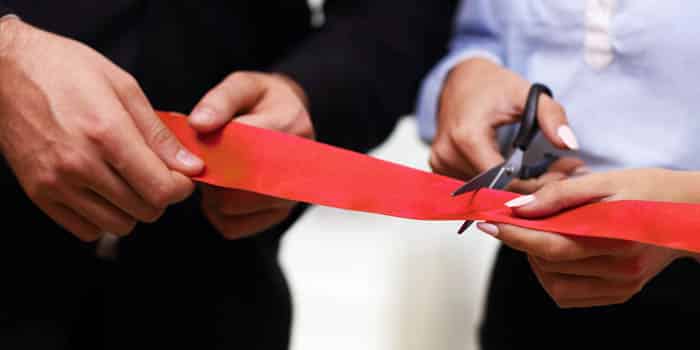 businesspeople-cut-red-ribbon-open-opening-news