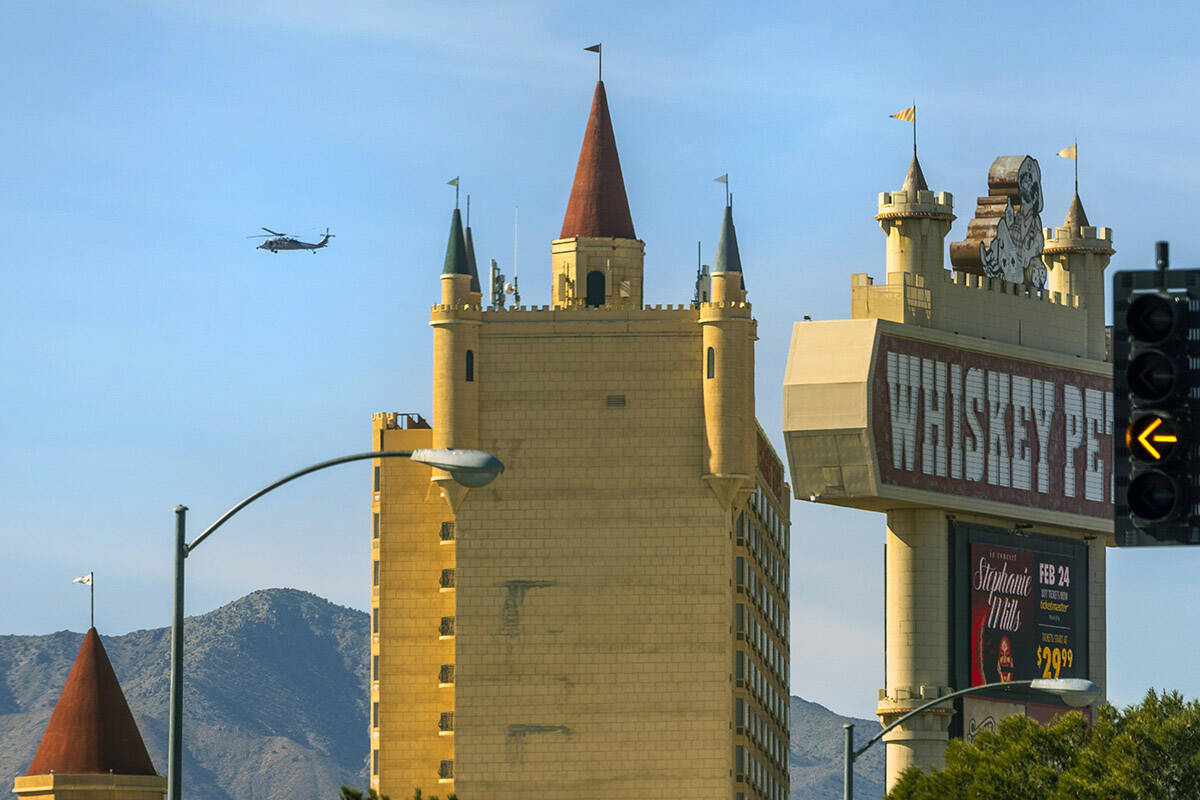 A helicopter cruises beyond the Whiskey Pete's Hotel & Casino on Friday, Jan. 26, 2024, in ...