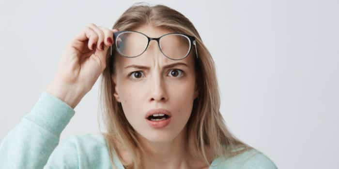 surprised-woman-taking-her-glasses-up